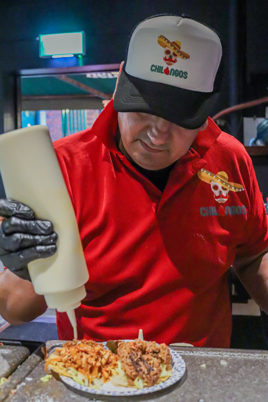 Chilangos chef plating tacos at the festival
