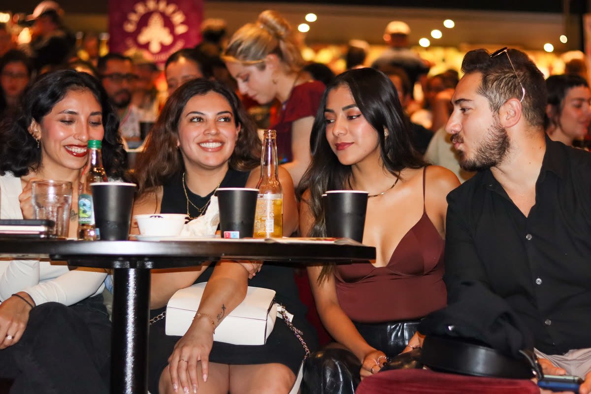 Guests smiling and enjoying the show at a table