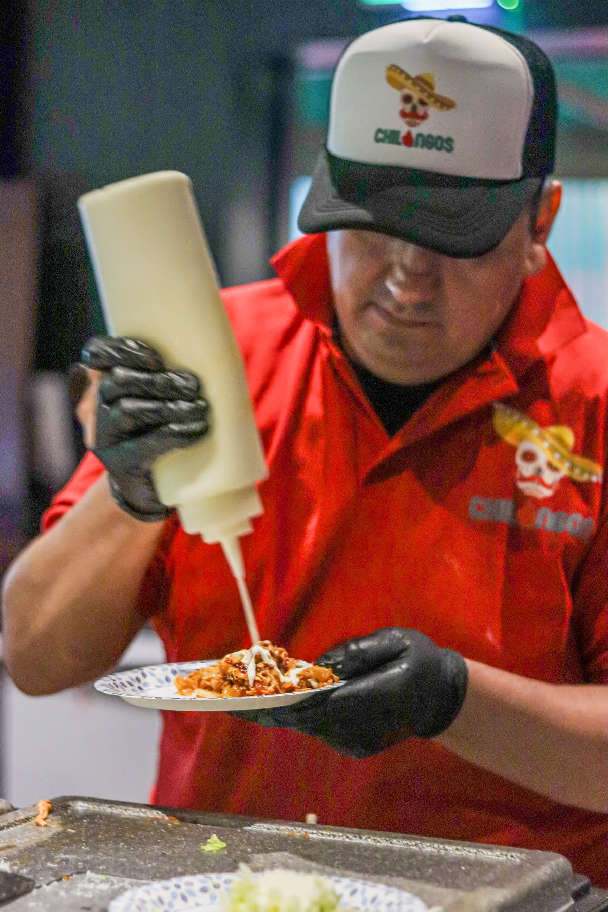 Chilangos chef plating a dish at the festival