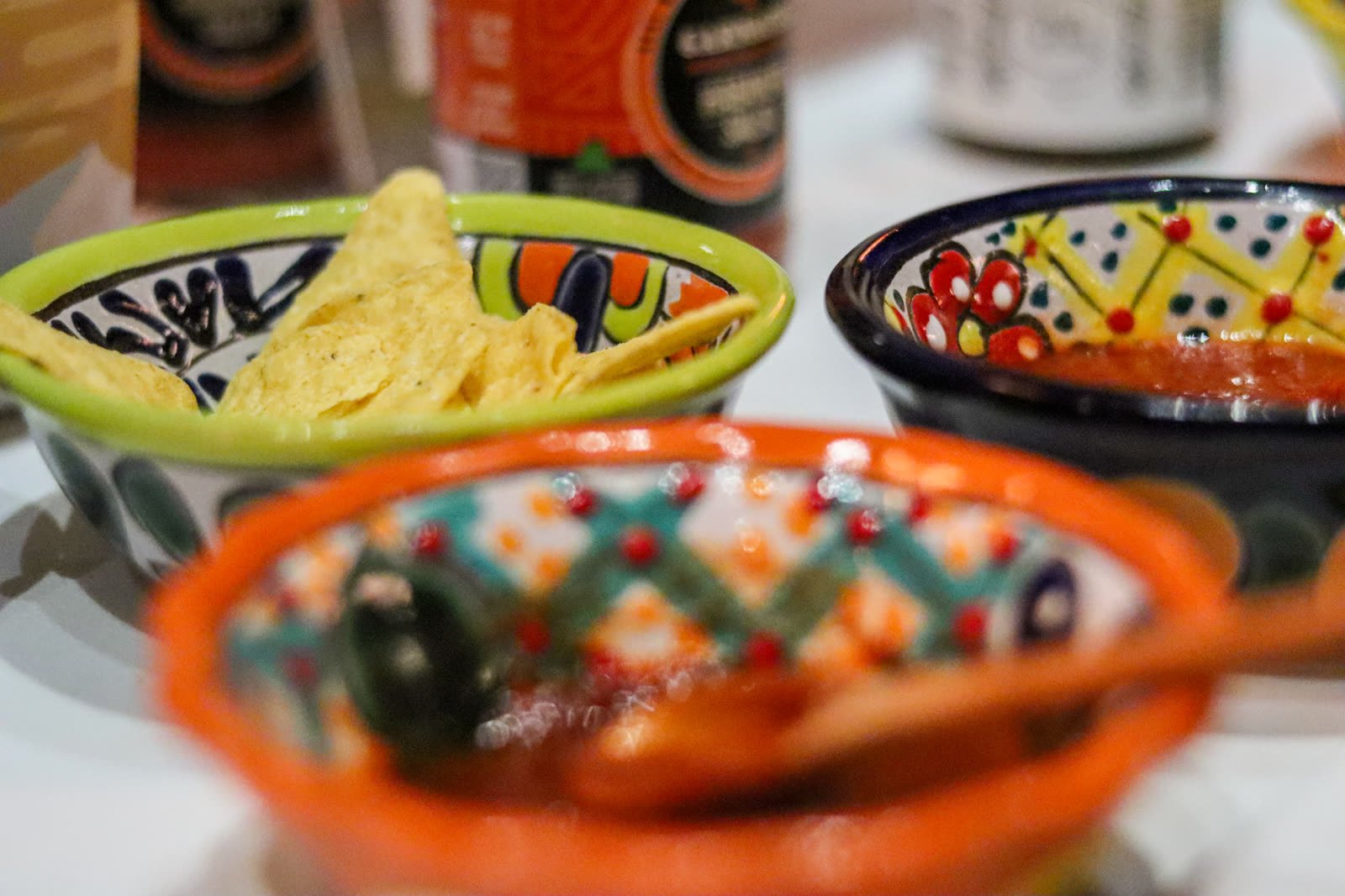 Chips and salsas served in hand-painted Mexican pottery