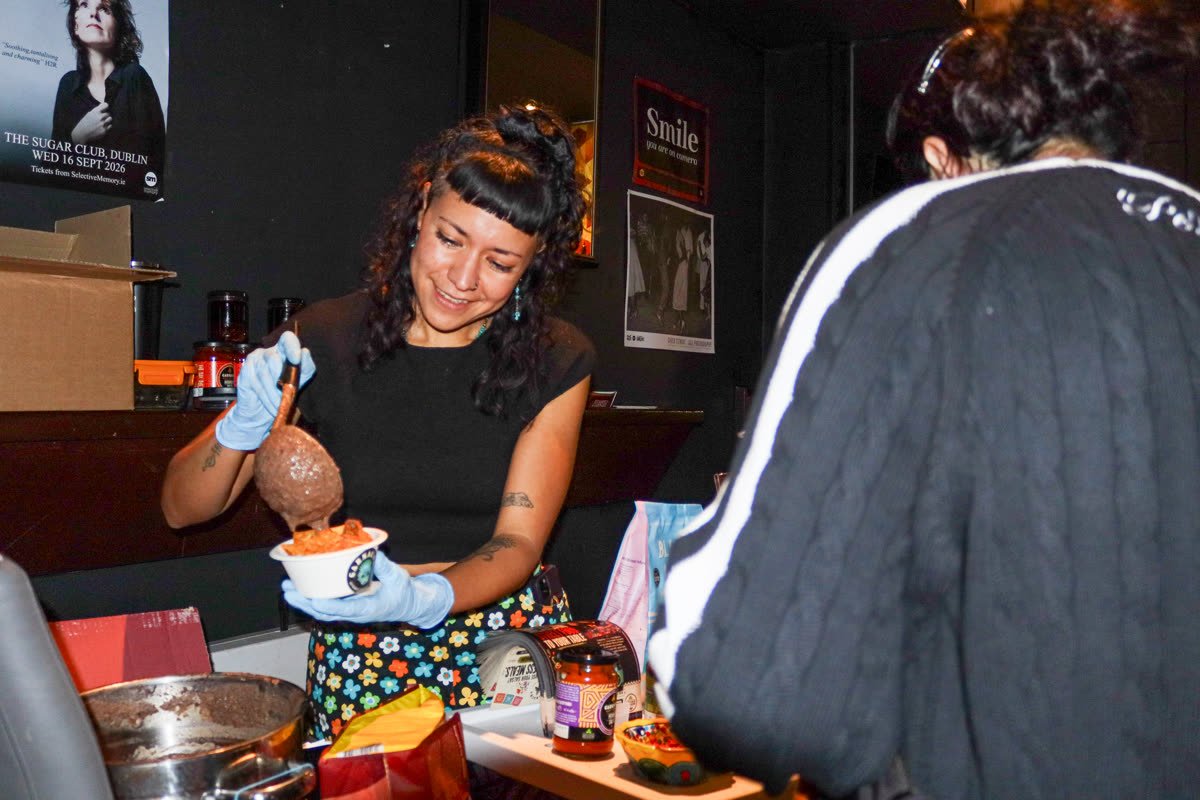 A Garnacha team member serving chips and salsa
