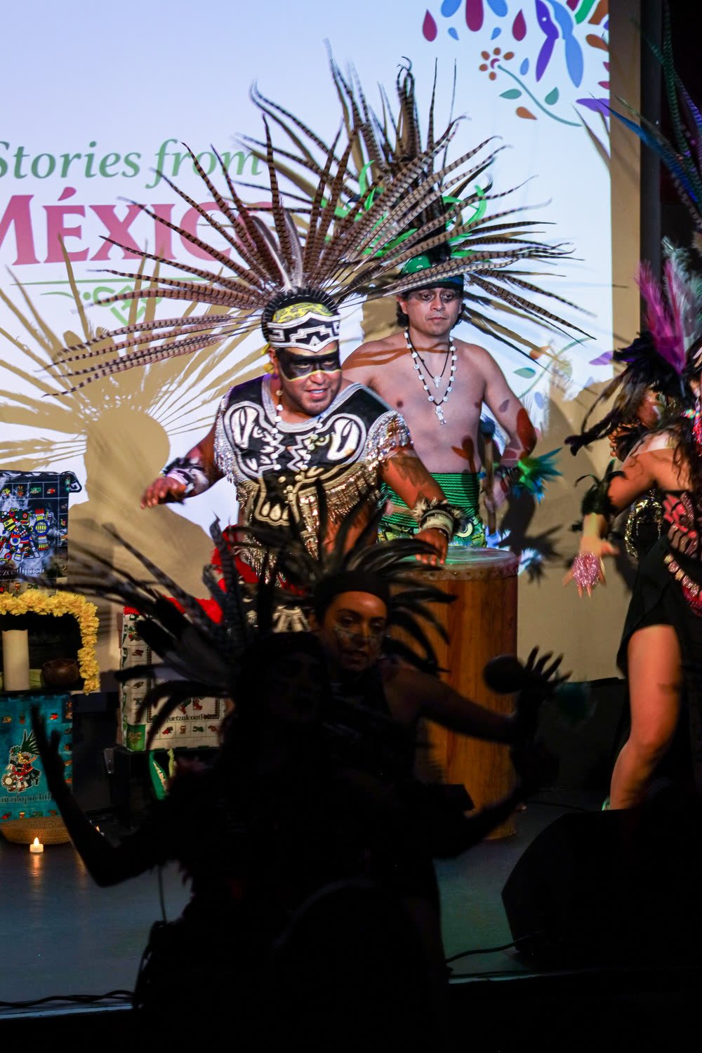 Calpulli Mictlán dancer in a feathered headdress performing the Traditional Aztec Dance