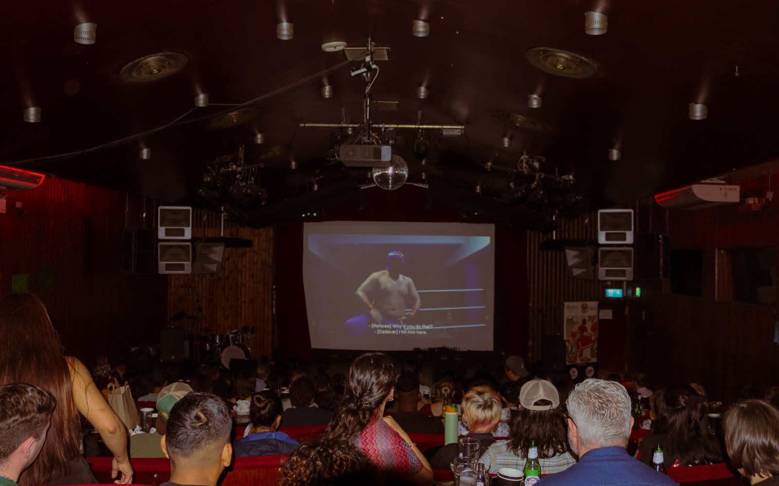 A packed crowd watching a film screening at Stories From México